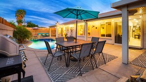 A backyard with a pool, patio furniture, and a grill. - Private Pool & Spa | Walk to Tennis Garden (La Quinta)