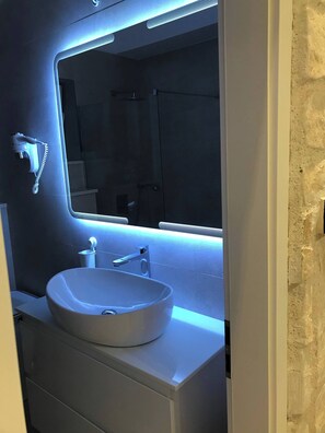 A bathroom with a white sink, a mirror with LED lighting, and a towel rack. - Vibehaus Center of Split City Only 400m From Beach (Split)