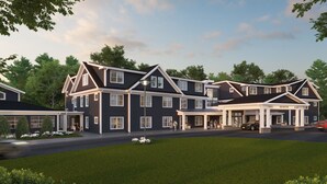 A large, two-story hotel with a covered entrance and multiple windows. - Hotel Bridgton (Bridgton)