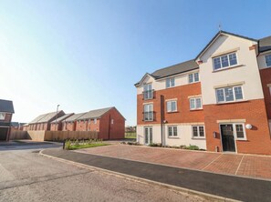 A residential building with a brick facade, multiple windows, and a flat roof. - Apartment 7 at Anfield (Liverpool)