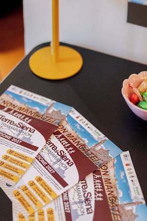 Una mesa con boletos de evento esparcidos y un frutero.