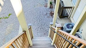 A wooden staircase leading to a building's entrance.