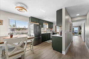 A modern kitchen with a central island, stainless steel appliances, and a view of the outdoors. - Beautiful waterfront 2 bedroom condo (Clearwater)