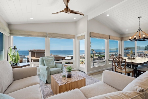 This home showcases panoramic ocean views through floor-to-ceiling windows