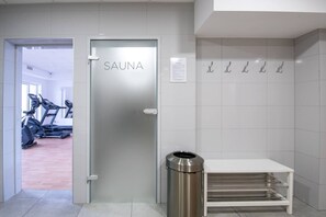 A modern, clean room with a sauna door, exercise equipment, and a trash bin. - 2Homerent | Garden terrace | Good location (Kołobrzeg)
