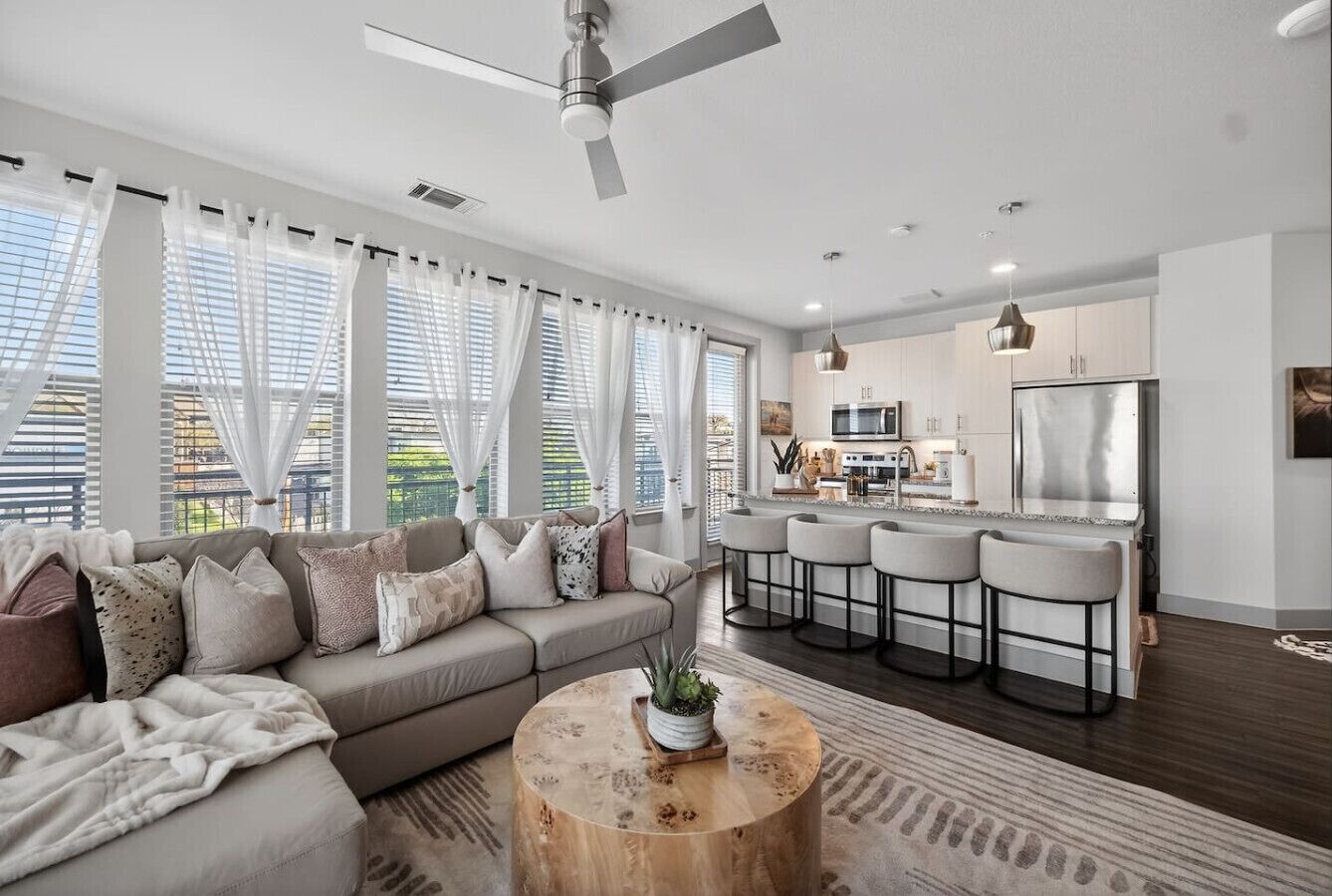 Living area: Bright and airy lounge with oversized windows, stylish décor, and plenty of seating for everyone.