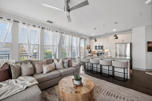 Living area: Bright and airy lounge with oversized windows, stylish décor, and plenty of seating for everyone.