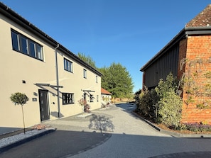 A street view with a building featuring a flat facade, multiple windows, and a door. - Pine Lodge (Bridgwater)
