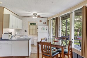 A compact kitchen with a dining area, a ceiling fan, and a view of the outdoors. - Luray retreat - Hiking and Shenandoah River nearby - Dog friendly (Page County)