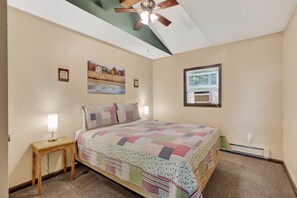 A bedroom with a bed, a nightstand, a ceiling fan, a window, and a painting on the wall. - Luray retreat - Hiking and Shenandoah River nearby - Dog friendly (Page County)