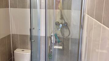 Shower, towels, soap, toilet paper