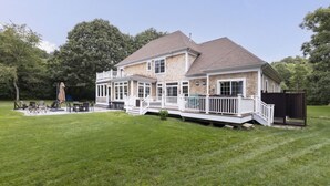 A two-story house with a covered porch, a fenced yard, and a small deck area. - Large, 4,300 sq. ft. custom built 5 BR home on private 2.2 acres in Watch Hill (Westerly)