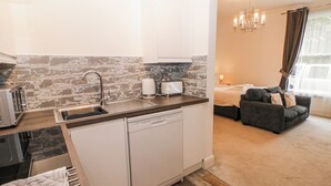 A compact kitchen with a dishwasher, a toaster, and a sink. - Arkwright (Matlock)