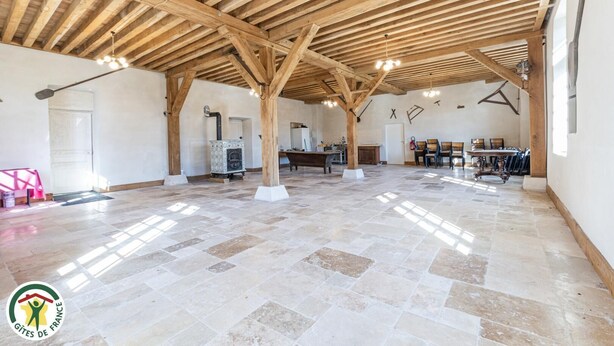 A spacious hall with a high wooden ceiling, stone flooring, and a central seating area with tables and chairs. - The Monastery - ORBAIS L'ABBAYE (ORBAIS L'ABBAYE)