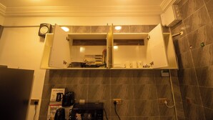 A bathroom with a built-in shelf, a mirror, and a shower area. - NimbusNiche Luxury Residence (Akaikrom)