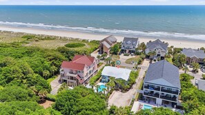A coastal residential area with houses, a swimming pool, and a beach view. - Wavecrest Grand with Pool Great for Groups (Surfside Beach)
