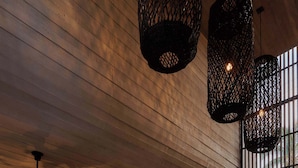 A reception area with a wooden ceiling, a reception desk, and a patterned floor. - Chic Studio with Pool, Steps to La Punta Beach (Puerto Escondido)