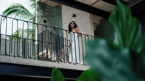 A balcony with metal railings, a concrete wall, and a palm tree in the background. - Chic Studio with Pool, Steps to La Punta Beach (Puerto Escondido)
