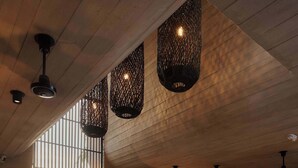A modern interior with a reception desk, seating area, and decorative lighting.