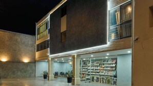 A building with a modern design, featuring a large display of artwork on the ground floor. - Historic Center Hotel - Walk to Santo Domingo Temple (Oaxaca de Juárez)