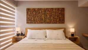 A hotel room with a large bed, two bedside tables with lamps, a headboard, and a large abstract painting on the wall. - Historic Center Hotel - Walk to Santo Domingo Temple (Oaxaca de Juárez)