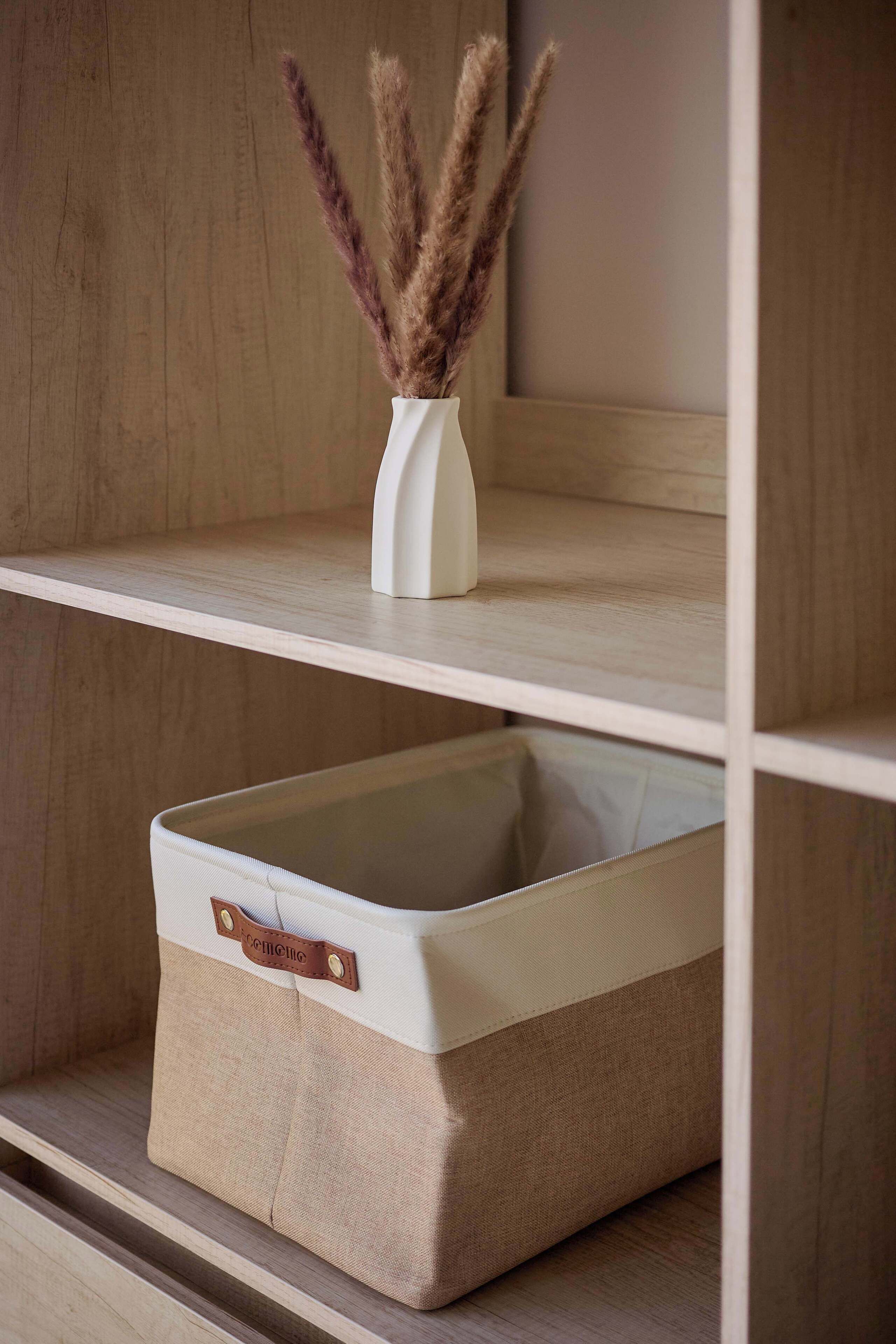 A storage box with a handle and a label, placed on a shelf.