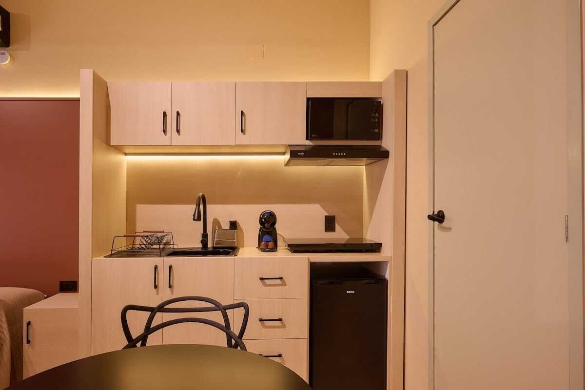 A compact kitchen with a microwave, toaster, and dishwasher.