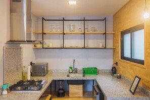 Microwave, stovetop, coffee/tea maker, cookware/dishes/utensils