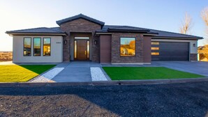 A modern two-story house with a garage, a front entrance, and a driveway. - Spacious Modern Home Near Zion & Grand Canyon (Colorado City)