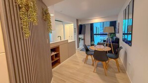 A modern hotel room with a dining area, a large window, and a view of the outside. - San Isidro financial district stay (404) (Lima)