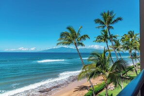 A beach view with palm trees and ocean waves. - Mahana Villas | Oceanfront 4 BR Sleeps 11 | Car Incl. w/ 6+ Nights | MAH ML-3714 by KBM (Lahaina)