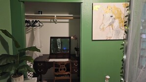 A room with a desk, chair, potted plant, and a painting. -  3-bedroom Garden house with AC/Hot tub in beautiful Eugene (Eugene)