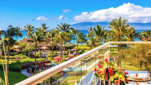 A resort with a pool, palm trees, and a view of the ocean. - Honua Kai | Ocean View 7 BR, Sleeps 20 | Car Incl. w/ 6+ Nights | HKK ML-3819 by KBM (Lahaina)