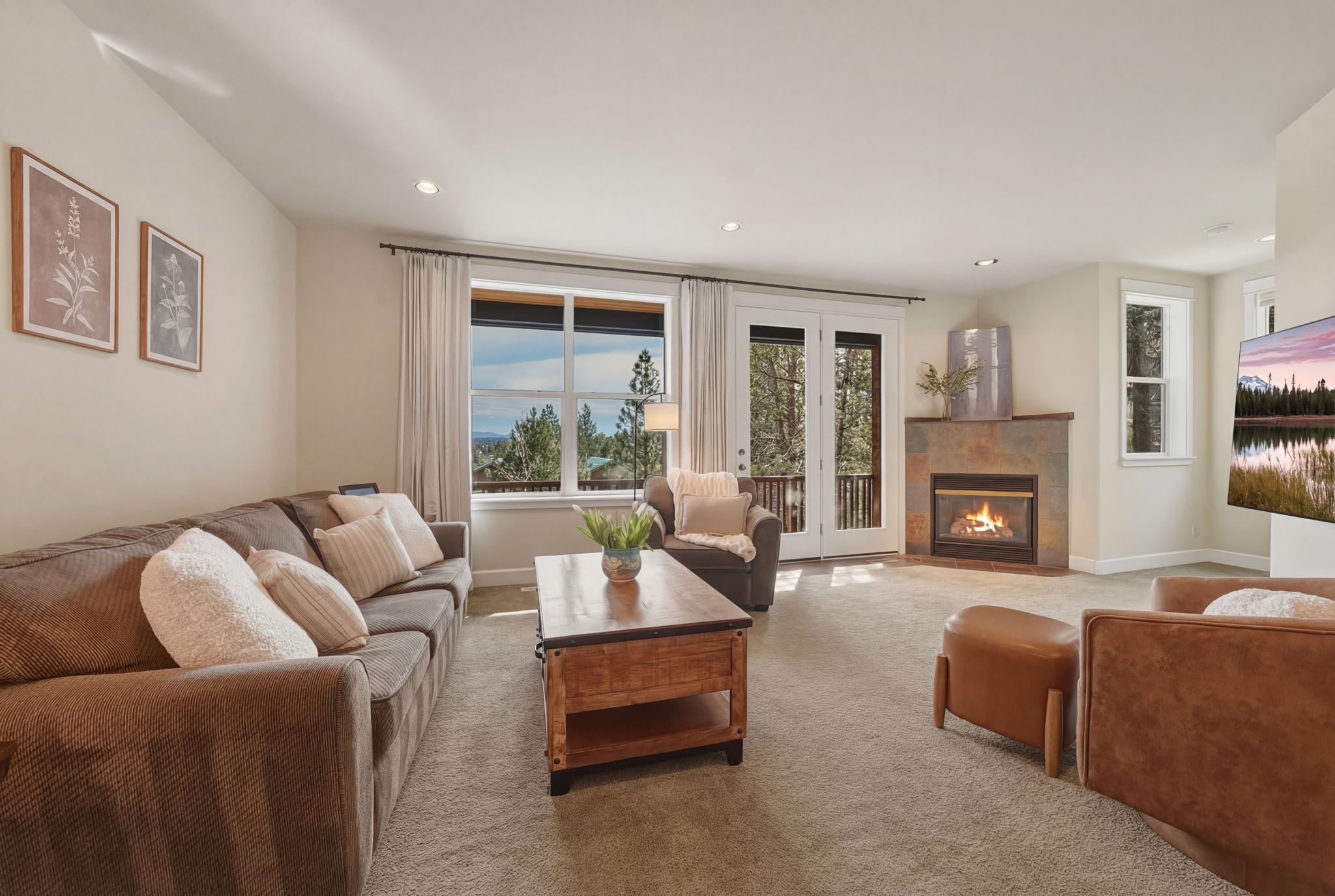 A living room with a fireplace, a sofa, a coffee table, and a television.
