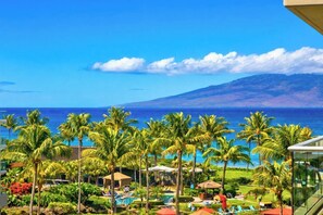 A resort with a pool, palm trees, and a view of the ocean. - Honua Kai | Ocean View 2 BR, Sleeps 8 | Car Incl. w/ 6+ Nights | HKK ML-3896 by KBM (Lahaina)