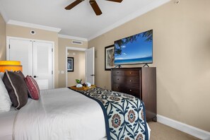 A bedroom with a bed, a television mounted on the wall, a ceiling fan, and a dresser. - Honua Kai | Ocean View 7 BR, Sleeps 20 | Car Incl. w/ 6+ Nights | HKK ML-3915 by KBM (Lahaina)