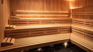 A sauna with wooden benches and slatted seats, a tiled floor, and a ceiling with a linear light fixture. - Residance with pool ,sauna and free garrage (Budva)