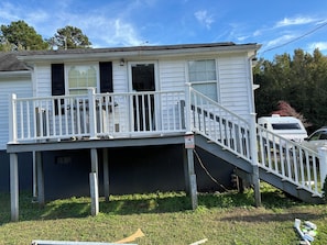 A two-story house with a balcony, a staircase, and a garage.