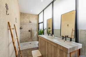 A modern bathroom with a shower, two sinks, a mirror, and a bamboo ladder. - Thula Lembongan Villa 3 (Lembongan)
