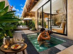 A couple in a private pool area with a dining setup and a view of the bedroom. - Thula Lembongan Villa 3 (Lembongan)