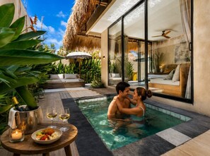 A couple in a private pool area with a dining setup and a view of the bedroom. - Thula Lembongan Villa 3 (Lembongan)