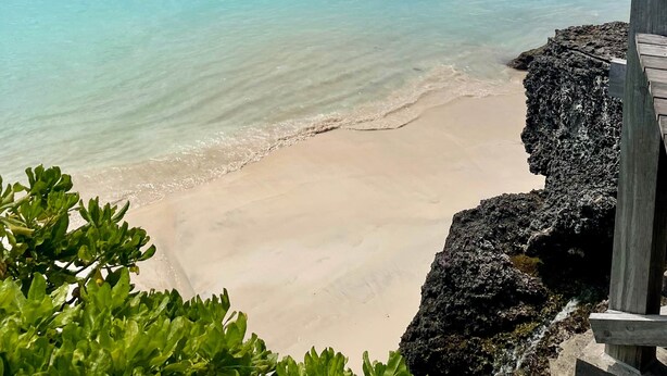 A coastal view with boats on the water, a sandy beach, and rocky outcrops. - Thula Lembongan Villa 5 (Lembongan)