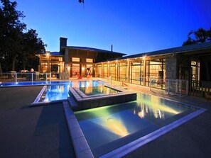 A modern building with a pool area, large windows, and a stone facade. - Chalet with terrace - 6 guests (Albi)