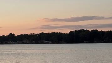 A body of water with a silhouette of a person swimming.