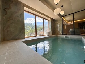 A modern indoor swimming pool with a view of mountains and a large window. - Exceptional Chalet in Vars – 21 guests, 450 sqm, 3 suites (Vars)