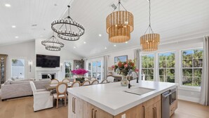 A spacious kitchen with a large island, wooden cabinets, and a built-in dishwasher. - Wagon Wheeler 6 Bed 4 Bath Private Pool Close to Gulf & Village Sleeps 12 (Boca Grande)