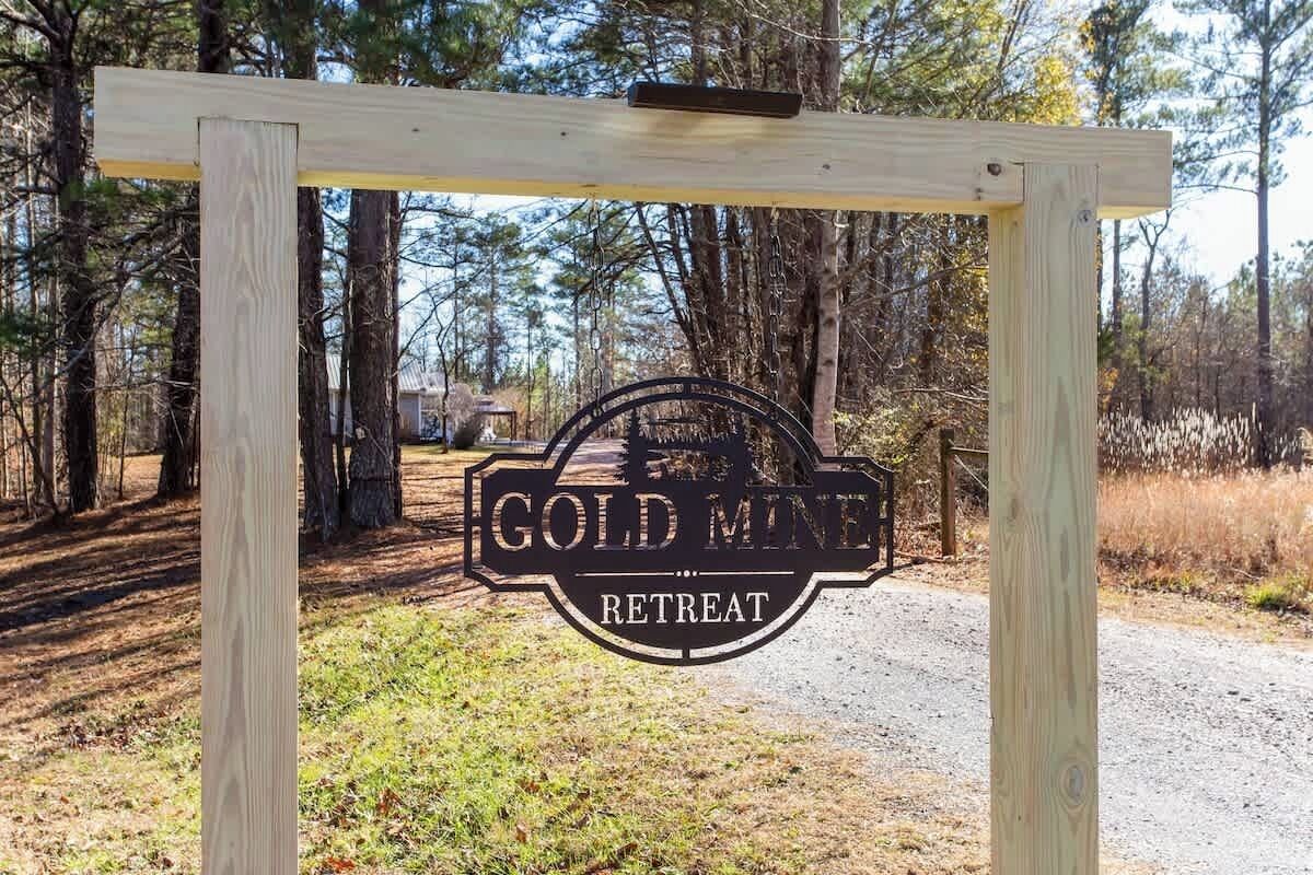 A wooden sign with 'GOLD MINE RETREAT' text.