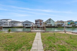 A waterfront property with a central walkway, a small pool, and a variety of colorful buildings. - Blushing Mermaid (North Myrtle Beach)