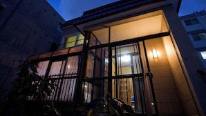 A building with large windows, a balcony, and a tiled roof. - [Sapporo Private House ] 8-minute walk from subway station and airport bus stop (Sapporo)