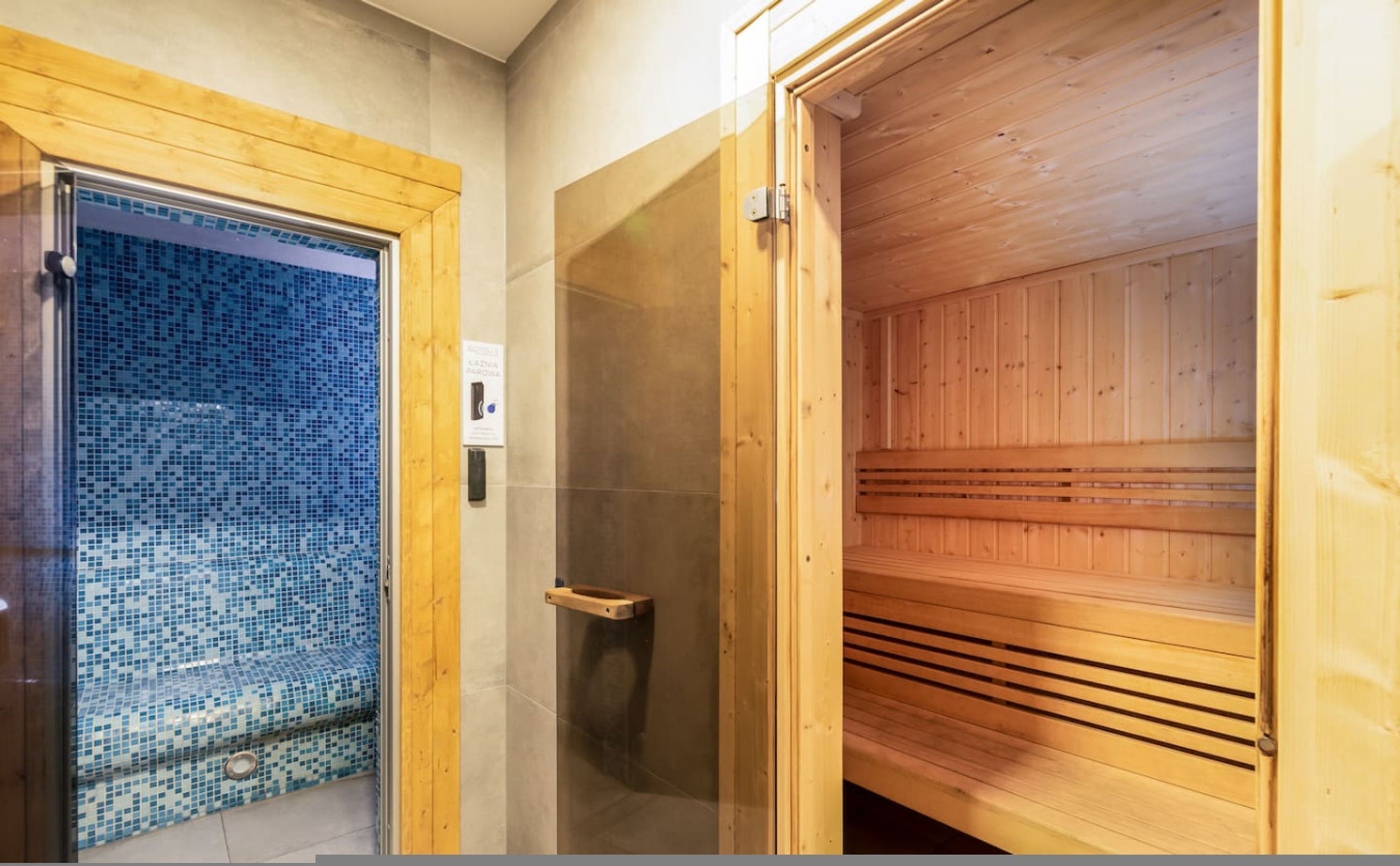 A sauna room with wooden walls and a tiled floor.